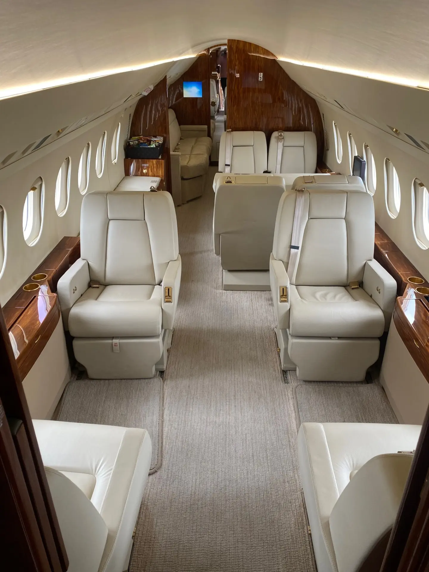 Private jet cabin with white leather club seating